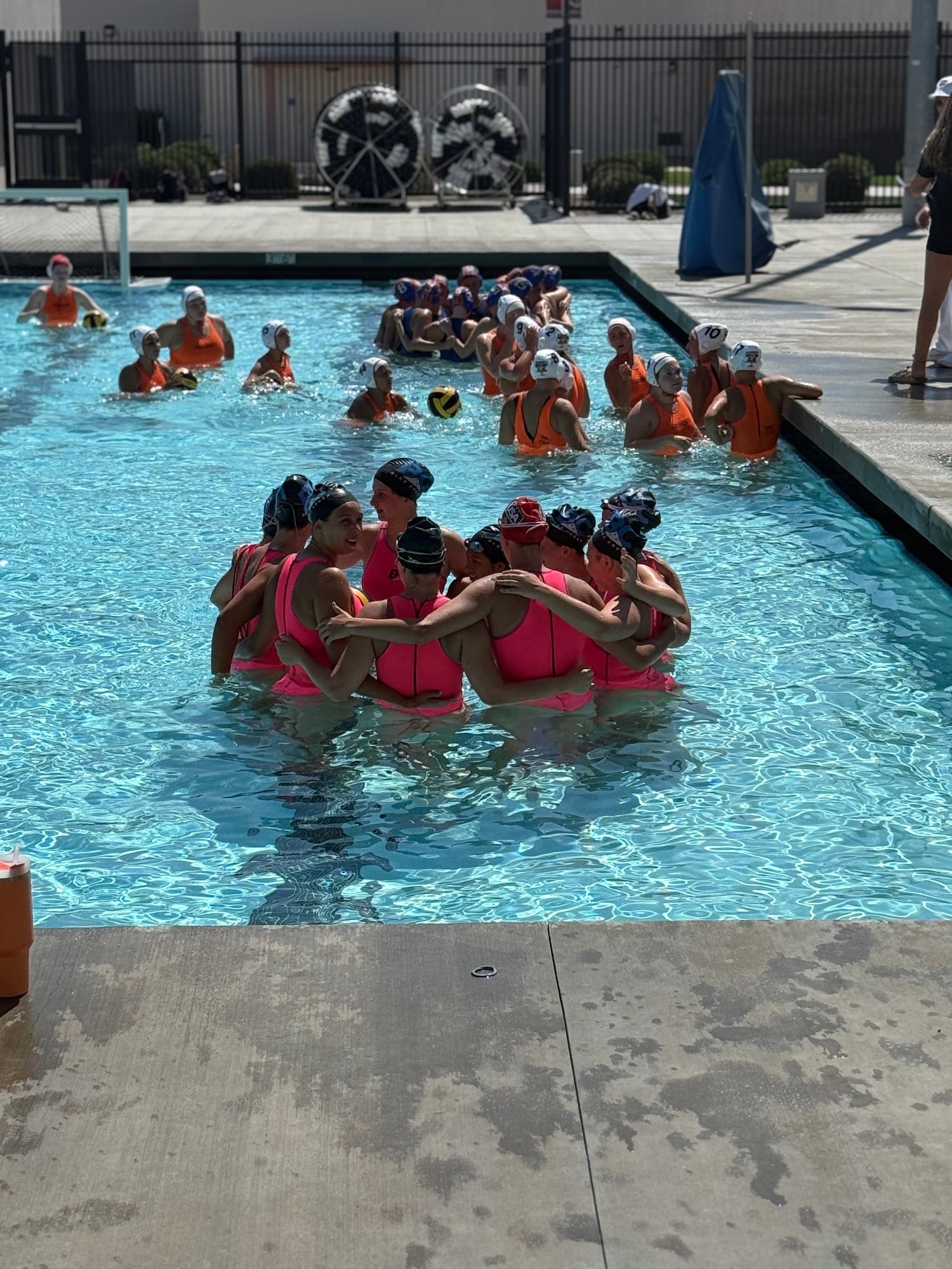 Water polo players in a huddle during a match